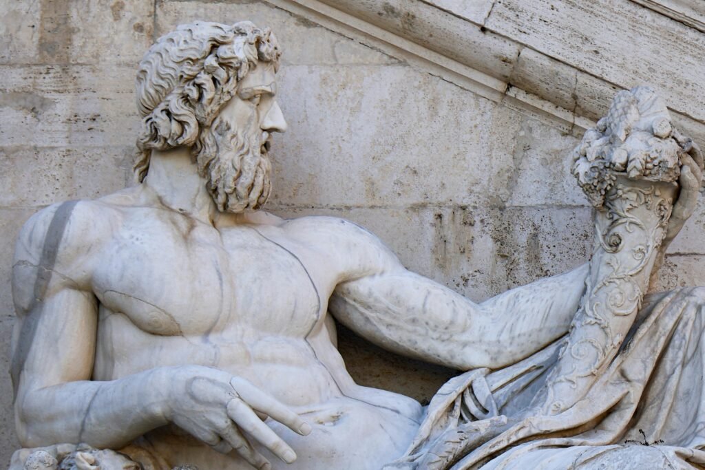 Close-up of Tiberinus, Roman god statue at Campidoglio, Rome, highlighting intricate details.